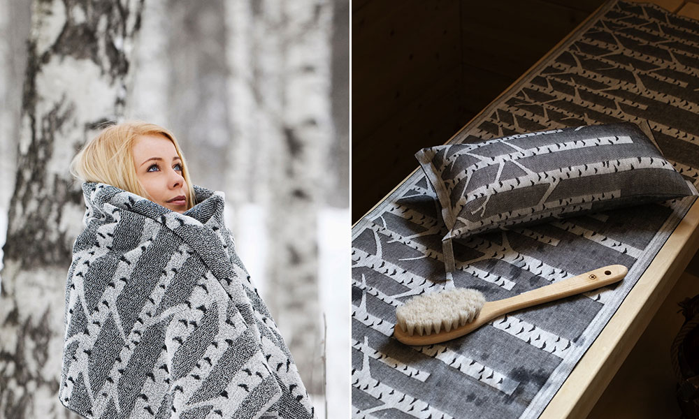 Hochwertige Sauna-Textilien der finnischen Marke Lapuan Kankurit im stilvollen Birken-Design „Koivu“. Links ist eine blonde Frau zu sehen, die sich in ein großes Duschtuch aus Leinen-Baumwoll-Mix einhüllt – perfekt für kalte Wintertage. Der Hintergrund mit verschneiten Birken unterstreicht die natürliche, nordische Ästhetik. Rechts sind Saunakissen, Handtuch und eine Massagebürste auf einer Holzbank arrangiert – ideal für Sauna, Wellness oder Spa-Bereich. Die harmonisch aufeinander abgestimmten Accessoires vermitteln Wärme, Entspannung und skandinavisches Design.