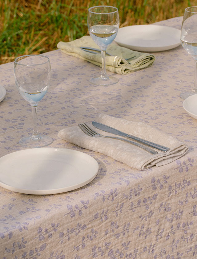 Lapuan Kankurit Meirami als Tischdecke – Gold-Lavender gefärbtes Leinen mit zeitlosem Kräutermuster.