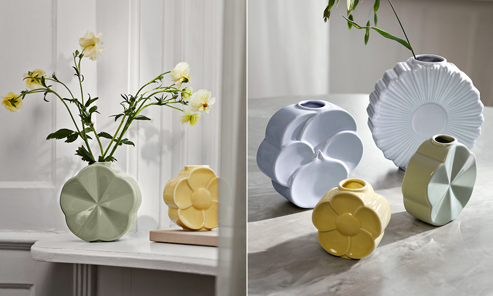 Helles Stillleben in zwei Motiven: Pastellfarbene Porzellanvasen der Serie Lyngby Flower stehen einmal auf einer weißen Fensterbank (eine Vase mit zarten Blüten), einmal als Gruppe auf einer hellen Steinfläche im Tageslicht. Die Formen sind blüteninspiriert, reduziert und grafisch. Hersteller ist Lyngby Porcelæn; die Serie umfasst vier Vasen-Modelle: Margerite, Stiefmütterchen, Ackerwinde und Butterblume.