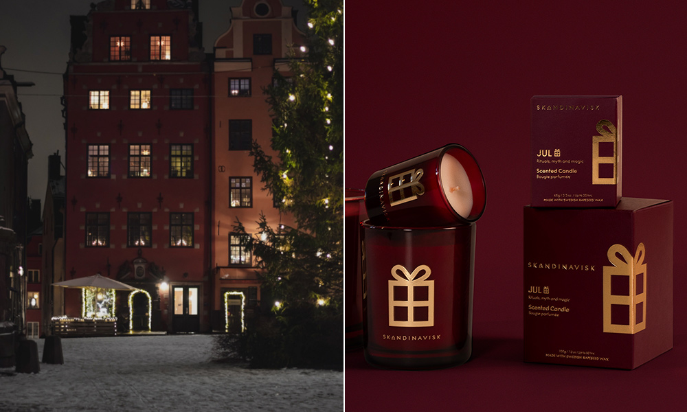 Skandinavisk JUL Duftkerze in roter Geschenkverpackung vor winterlicher Weihnachtskulisse in Skandinavien